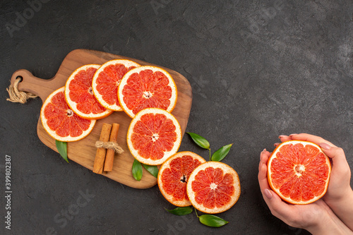 top view fresh grapefruit slices on dark background fruit healthy life color orange juice taste