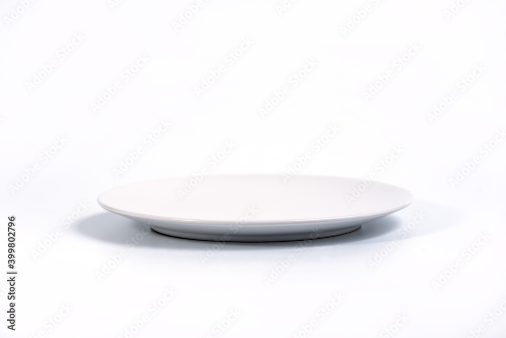 Empty White plate isolated on white background side view, selective focus Empty White plate isolated on white background side view, selective focus