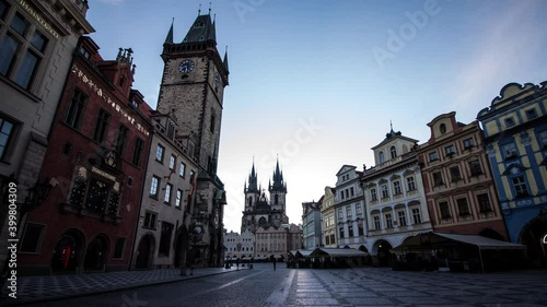 Sunrise timelapse of Old Town Square in Prague, Czech Republic with a view of Old Town Hall and Astronomical Clock and St. Tyn church with night to day transition photo