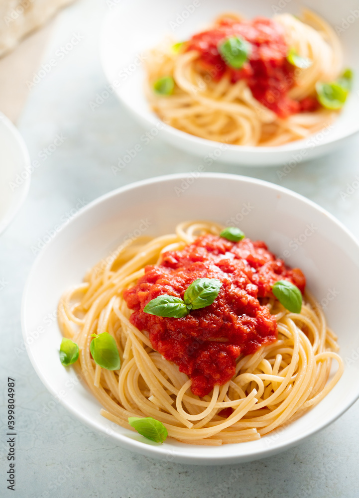 Spaghetti with tomato sauce and basil on a plate