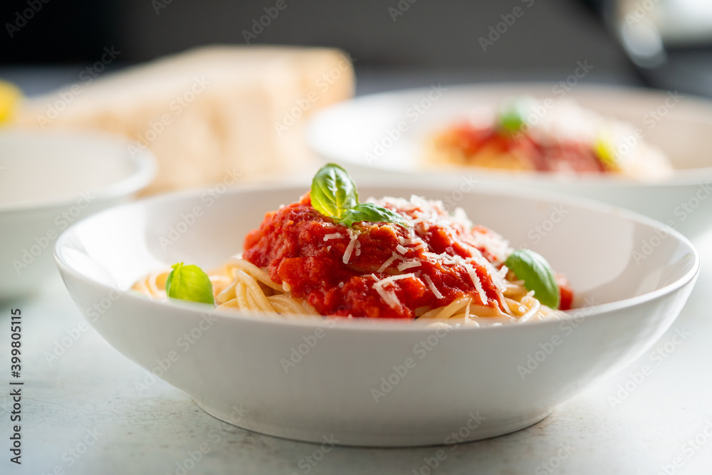Spaghetti with tomato sauce and basil on a plate Spaghetti with tomato sauce and basil on a plate