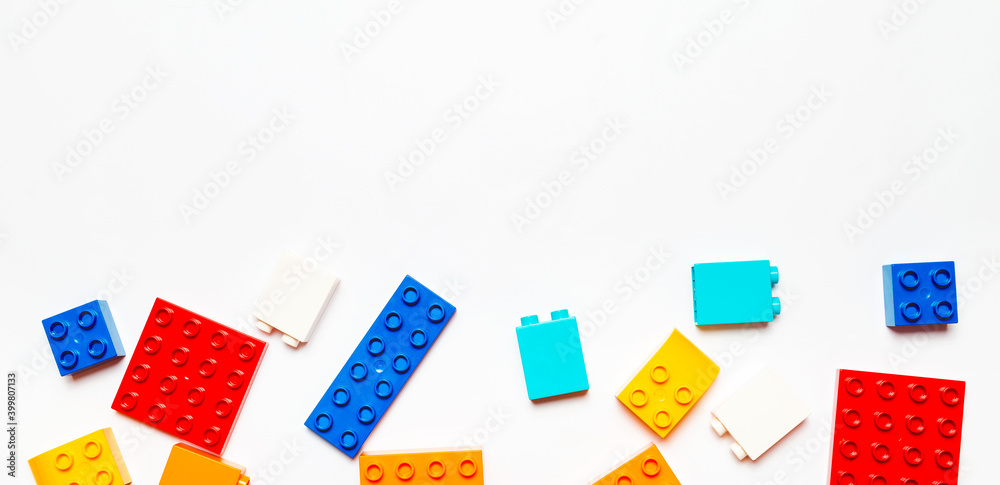 Baby toys frame on a white background. View from above. Flat lay. Copy space for text. Construction block for or toddler kid Baby toys frame on a white background. View from above. Flat lay. Copy space for text. Construction block for or toddler kid
