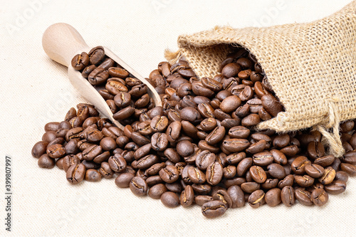 Bag with fresh roasted coffee beans isolated on on white cloth.