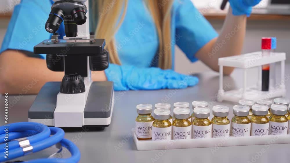 Woman laboratory researcher working with blood samples test tubes Woman laboratory researcher working with blood samples test tubes