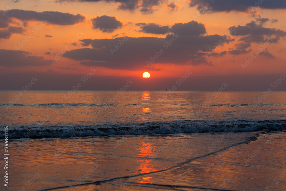 Fototapeta premium Amazing sunset over the ocean. Beautiful clouds and sun. Bright colors. 