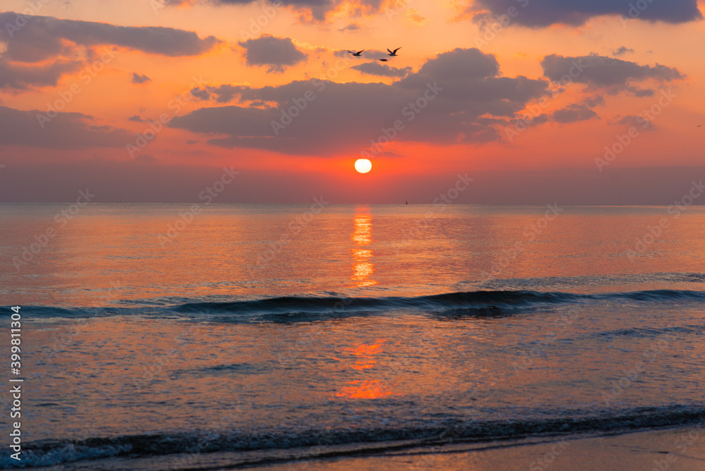 Amazing sunset over the ocean. Beautiful clouds and sun. Bright colors. Amazing sunset over the ocean. Beautiful clouds and sun. Bright colors.
