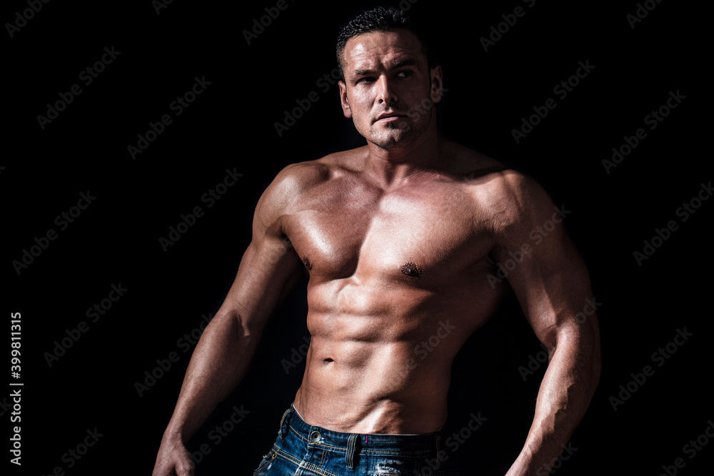 Torso with six pack and ab muscle. Abs and biceps. Strong brutal guy. Sexy torso. Handsome big muscles man posing at studio. Muscular sexy man. Handsome sexual strong man with muscular body