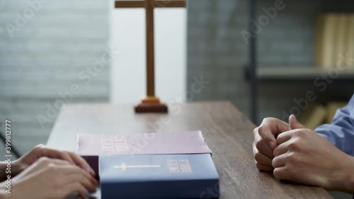 hands of Christian praying on Holy BIBLE in the church  photo