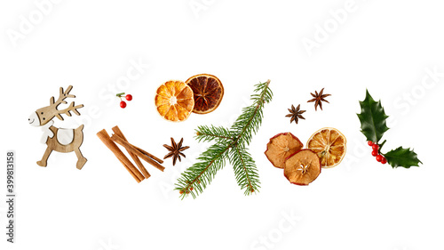 Fototapeta Naklejka Na Ścianę i Meble -  Christmas aromatic decoration with  wooden deer, spices, dried fruits and fir branch isolated on white