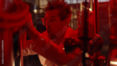 Scientist panicking in large laboratory during emergency