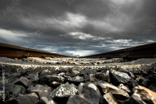 Gleisbett unter dunklen Wolken photo