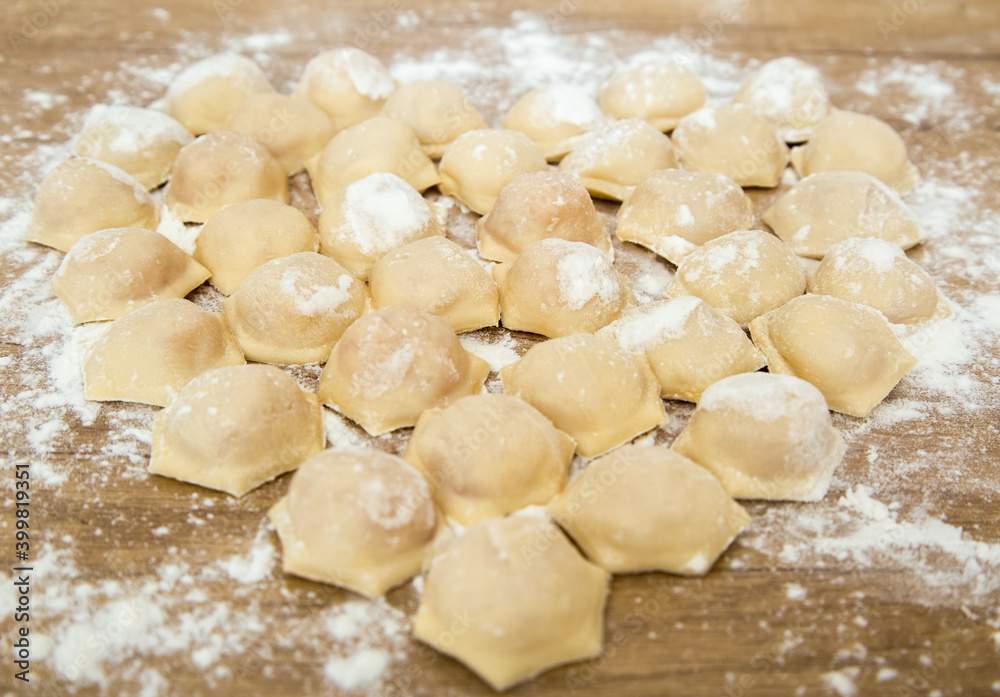 Dumplings cooked at home. Raw blinded dumplings on the table. A dish for Valentine's Day. DIY. Step by step. Step 6 Dumplings cooked at home. Raw blinded dumplings on the table. A dish for Valentine's Day. DIY. Step by step. Step 6