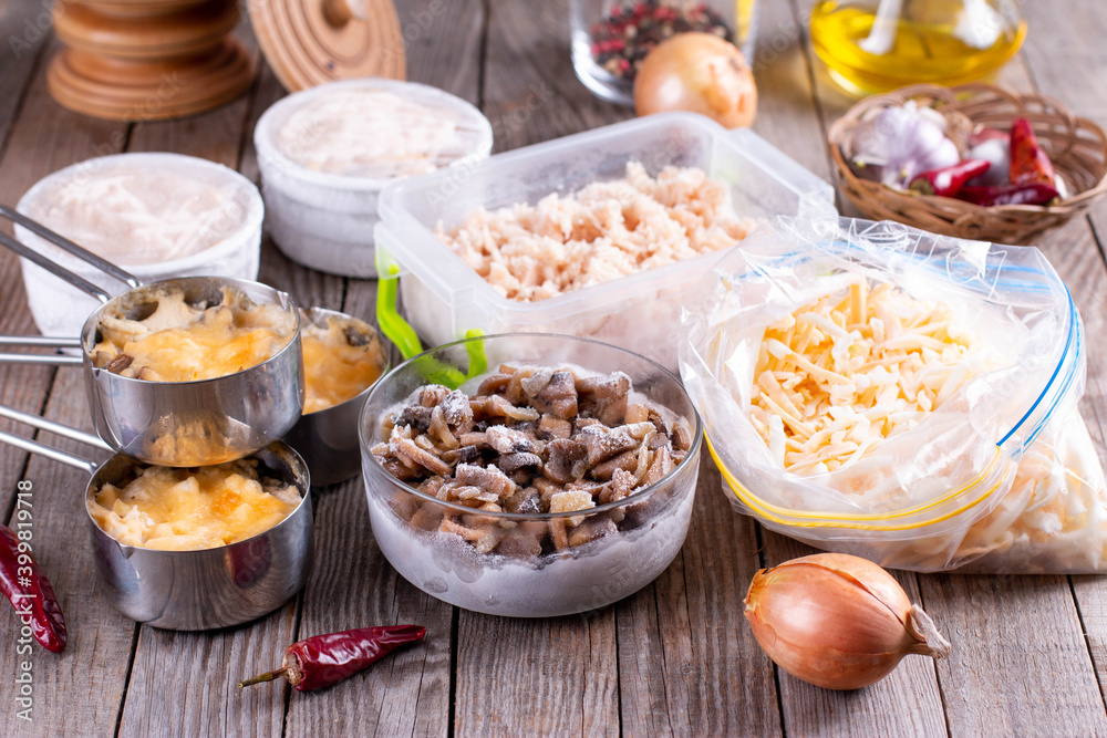 Frozen food. Frozen Casserole. Mushroom, chicken and cheese gratin in bowls on table Frozen food. Frozen Casserole. Mushroom, chicken and cheese gratin in bowls on table