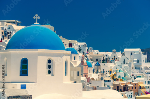 Church of Santorini. Fira town on Santorini island, Greece. Incredibly romantic view on Santorini. Oia village in the morning light. Amazing sunrise view with white houses. Island lovers