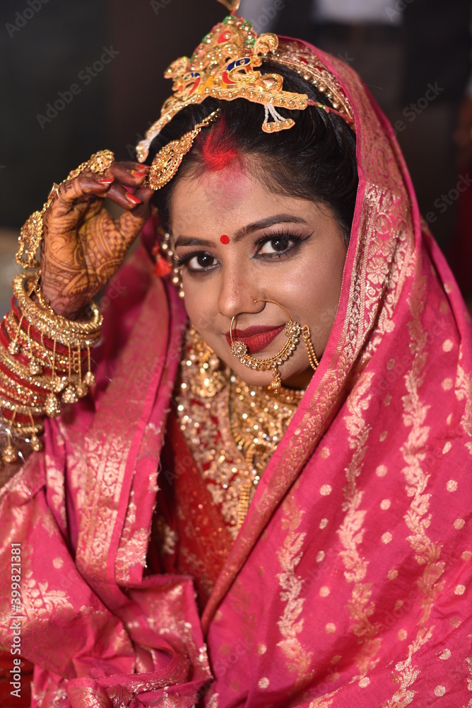 Bareilly, India 2019 : Indian bride flaunting the sindoor on her forehead. She is holding her jewellery to showcase her sindoor