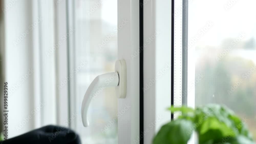 Hand of a Man Closing a Window from the Office Hand of a Man Closing a Window from the Office