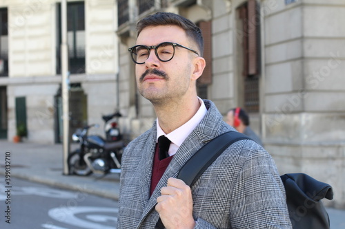 Businessman smelling something with eyes closed