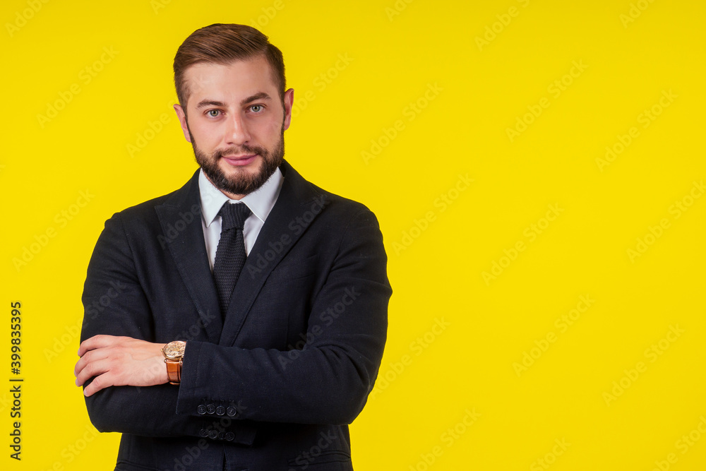 Portrait of young handsome man talking on the phone, holding smartphone next to ear isolated on yellow background Portrait of young handsome man talking on the phone, holding smartphone next to ear isolated on yellow background