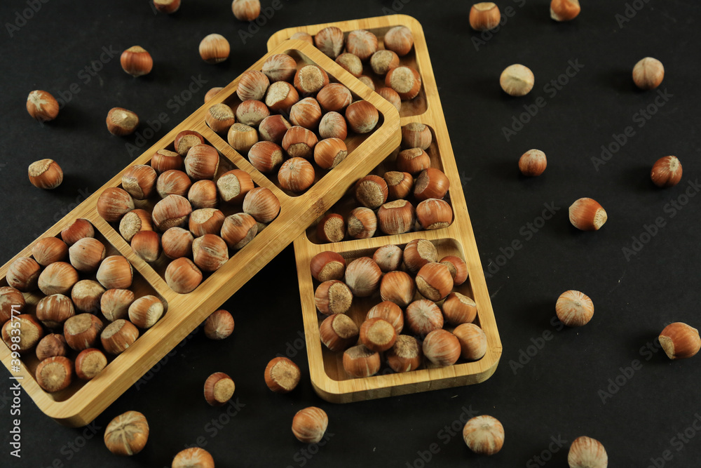 Hazelnuts on wooden backdrop. heap or stack of hazelnuts. healty food Hazelnuts on wooden backdrop. heap or stack of hazelnuts. healty food