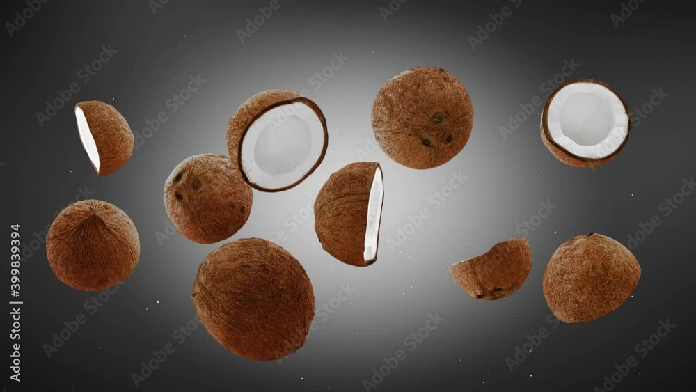 Flying of Coconuts and Slices in brown Background. Speed up and falling down coconuts with green screen. Professional slow motion 4K animation.
