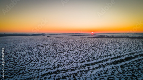 beautiful sunset in a winter frosty field