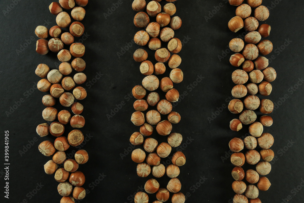 Hazelnuts on wooden backdrop. heap or stack of hazelnuts. healty food Hazelnuts on wooden backdrop. heap or stack of hazelnuts. healty food