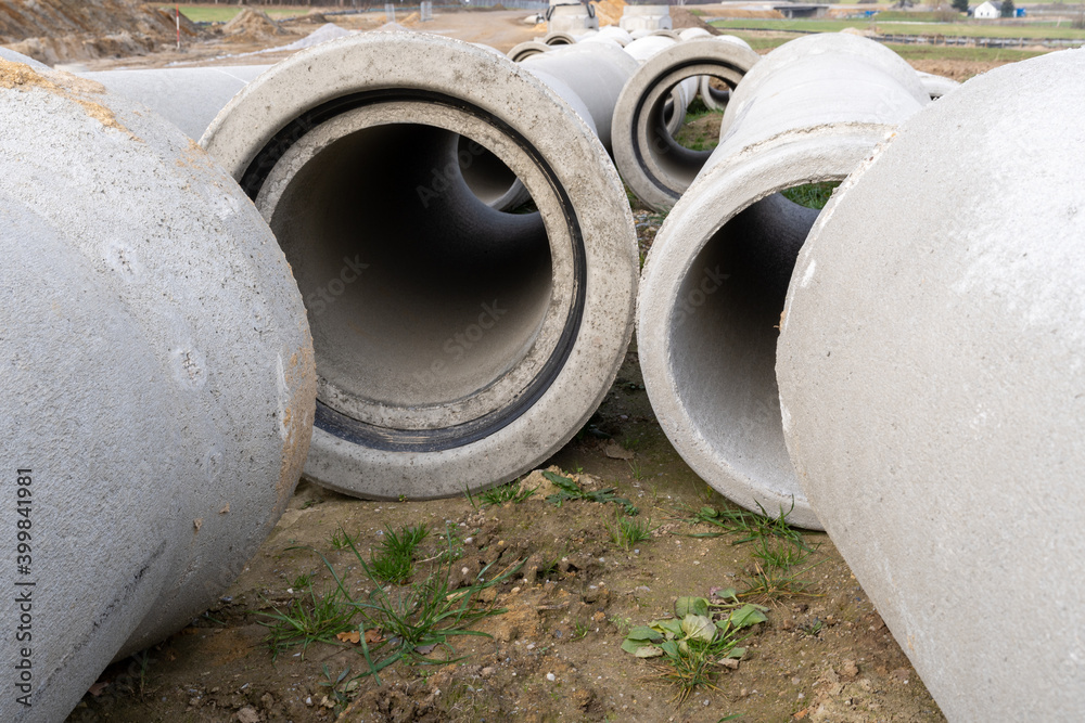concrete sewage pipes on the ground prepare for underground instalation concrete sewage pipes on the ground prepare for underground instalation