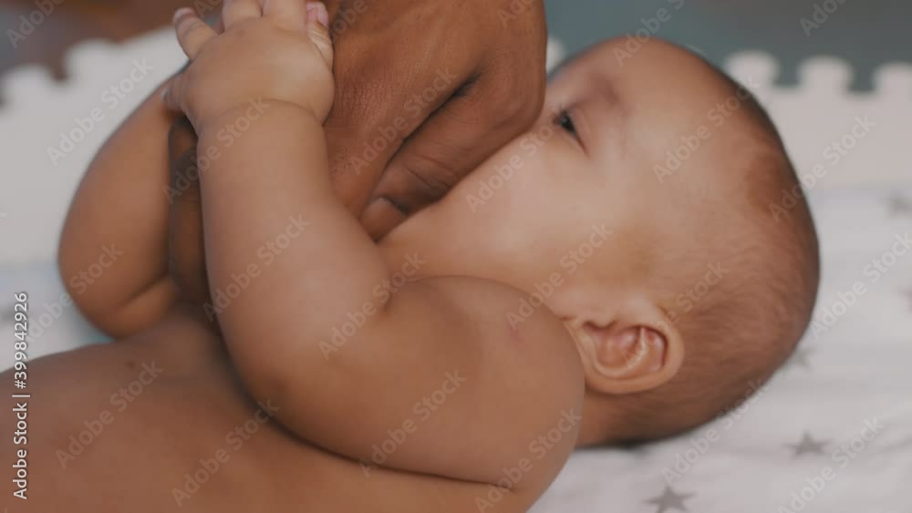 Close up black father tickling tummy of his newborn baby . Fatherhood and family. High quality 4k footage Close up black father tickling tummy of his newborn baby . Fatherhood and family. High quality 4k footage
