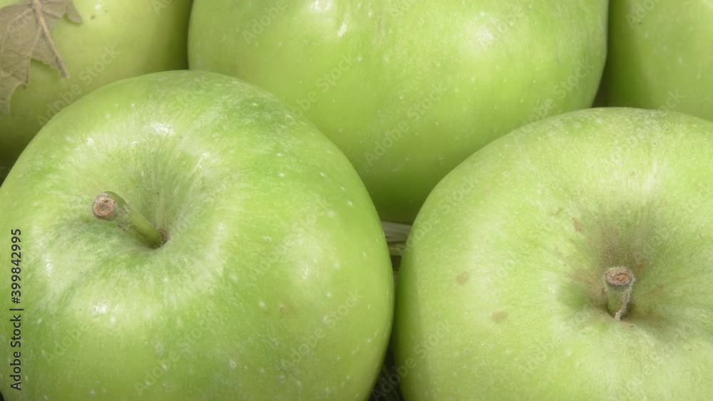 Organic green apples close-up. Ripe fruit on a hay. Organic green apples close-up. Ripe fruit on a hay.