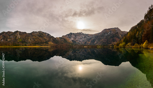 weak sun in a colorful mountain landscape on a lake panorama