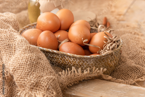 Fresh chicken eggs on a wooden table.