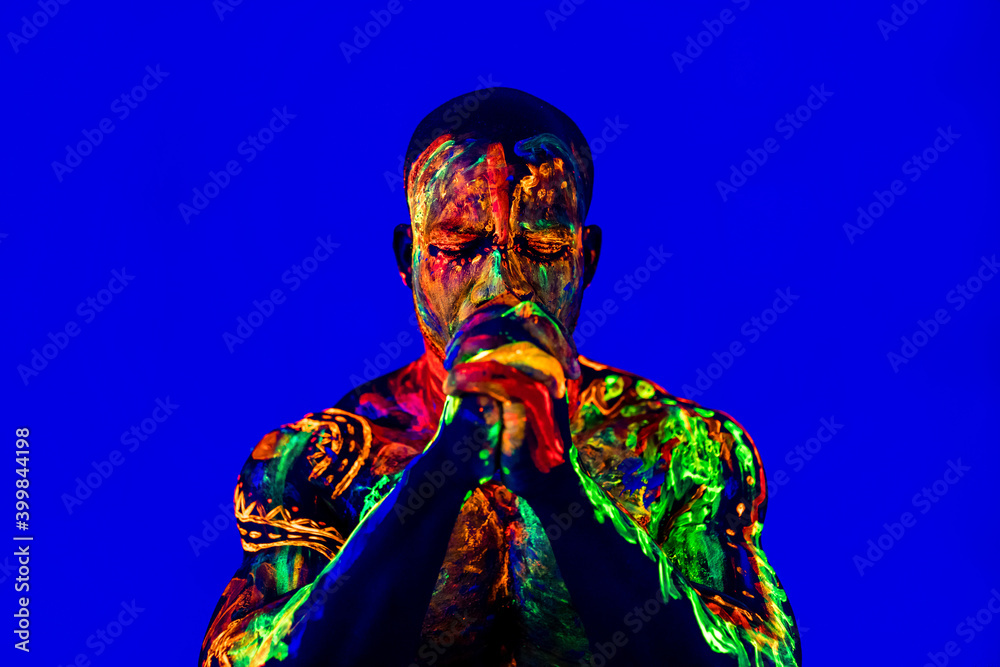 Fototapeta premium afro american man with UV body art posing in studio