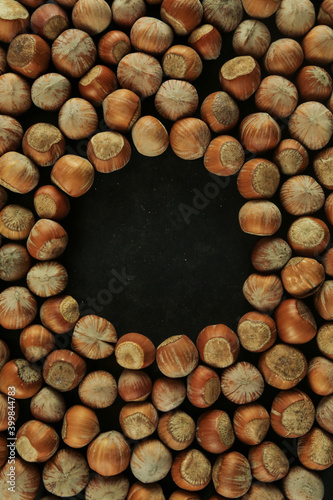 Hazelnuts on wooden backdrop. heap or stack of hazelnuts. healty food