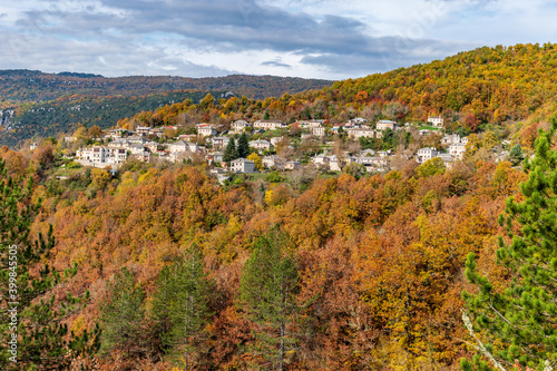 The picturesque village of kipoi during fall season with its architectural traditional old stone  buildings located on Tymfi mount, Zagori, Epirus, Greece, Europe photo