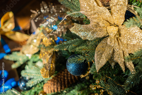Christmas background, living branches of spruce. Christmas decorations, Santa's mitten Pink and gold balls and Christmas bells. Festive background.