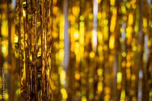 Christmas background, living branches of spruce. Christmas decorations, Santa's mitten Pink and gold balls and Christmas bells. Festive background.