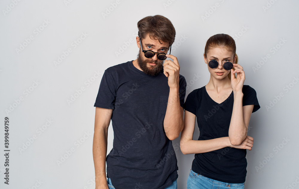 young couple black t-shirts sunglasses studio emotions romance Studio young couple black t-shirts sunglasses studio emotions romance Studio