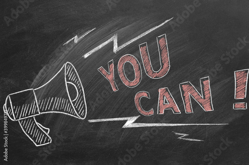 Loudspeaker with text You Can. Business motivational inspirational quotes. Illustration hand drawn in chalk on a blackboard. Words of motivation. Concept of ability and possibility.
