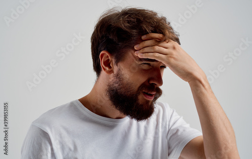bearded man holding his head discontent health problem disorder