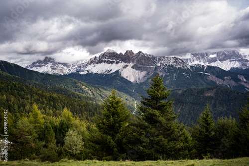 snow covered dolomites mountains in fall on cloudy day