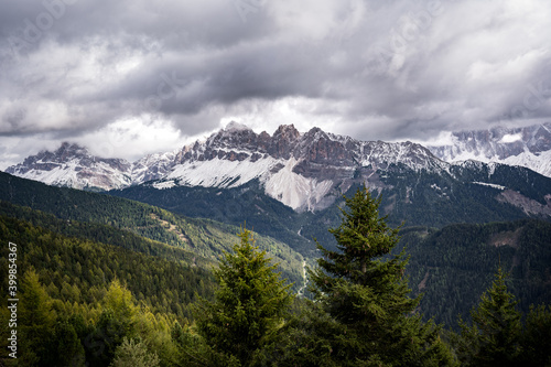 snow covered dolomites mountains in autumn on cloudy day