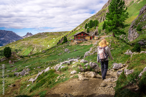 woman hiking to wooden house in the austrian alps