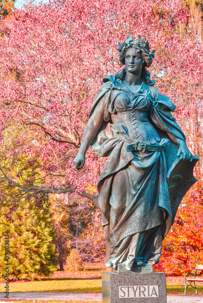 Statue representing Styria in the city park Stadtpark, a green island in the middle of the city, in Graz, Styria region, Austria, in autumn.