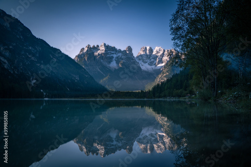 mountain reflects itself in the lake in the morning during sunrise