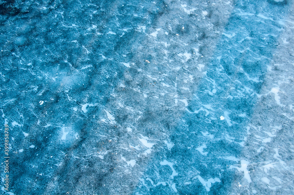 Obraz premium Abstract ice texture. Cracks in a piece of blue ice. Wave.