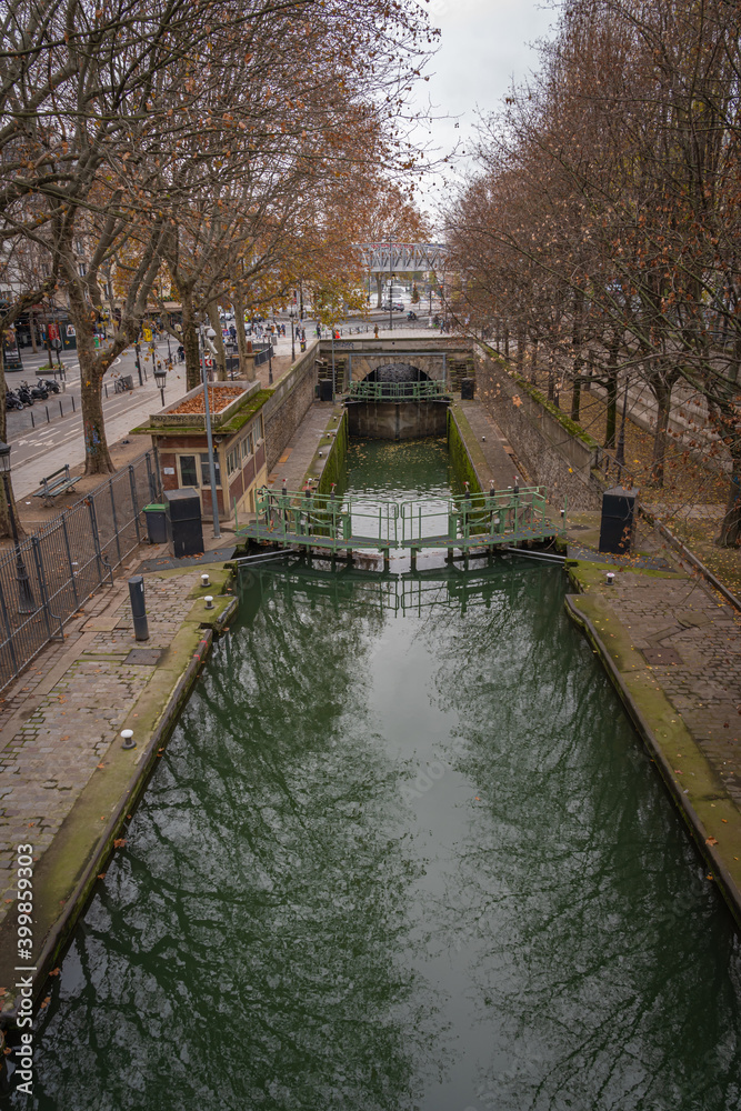 Paris, France - 12 12 2020: View of a Canal of the Basin of the villette with dam and bridges