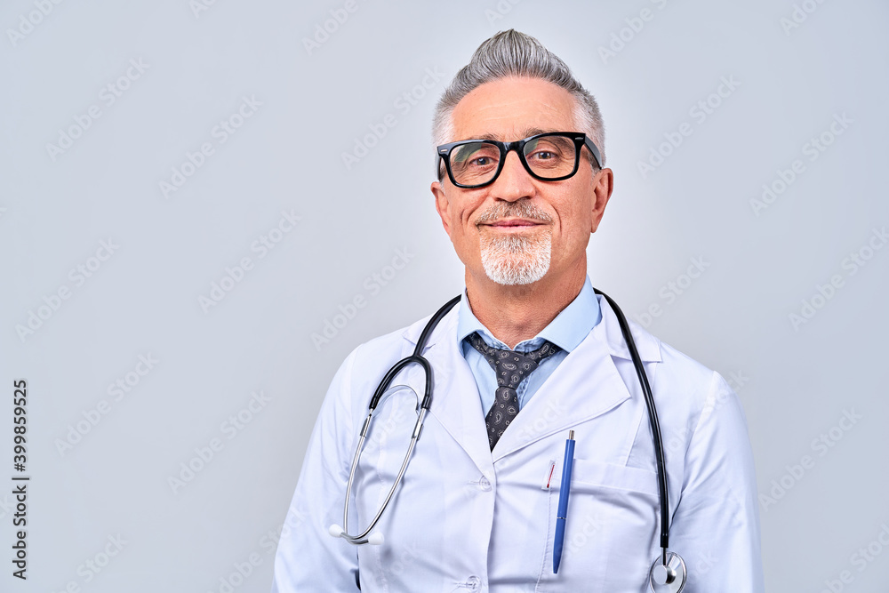 Cheerful adult doctor posing and smiling at camera Cheerful adult doctor posing and smiling at camera