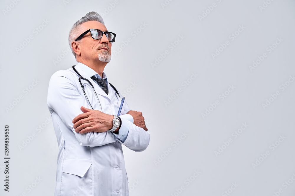 Confident therapist in black glasses standing with crossed arms Confident therapist in black glasses standing with crossed arms