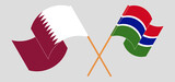 Crossed flags of Qatar and the Gambia