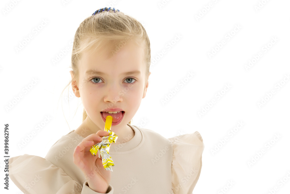 Cute little girl licks a candy. Cute little girl licks a candy.